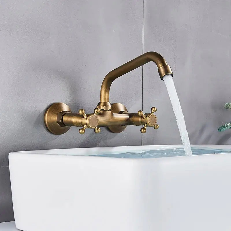DecorBites™ antique brass dual handle wall mount kitchen faucet with curved spout and ornate cross-handle knobs