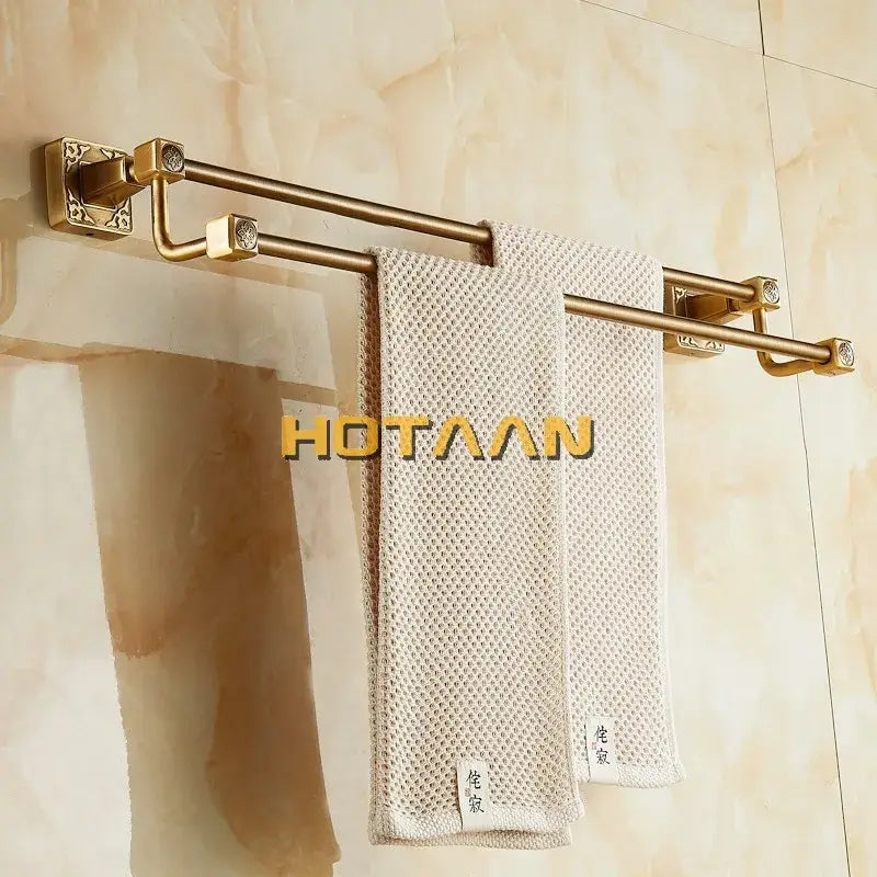 Brass double towel bar with ornate square wall mounts and decorative end caps in antique brass finish solid aluminium