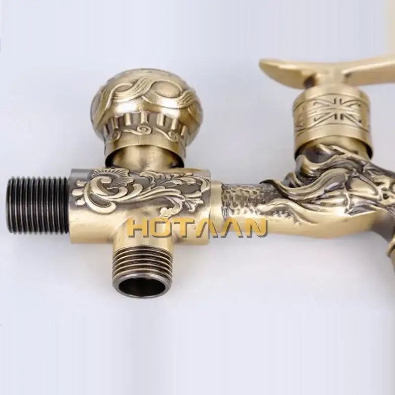 Brass finish garden bibcock faucet with antique brass finish featuring ornate dragon design and floral engraving
