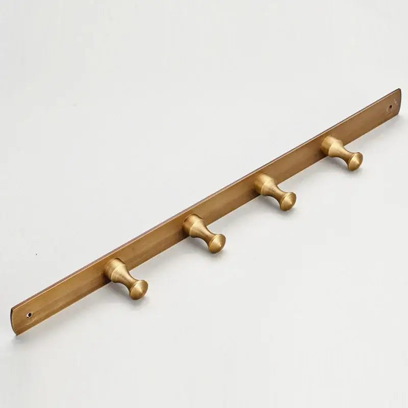 Brass-colored DecorBites™ antique brass finish robe hook with four rounded pegs for bathroom accessories