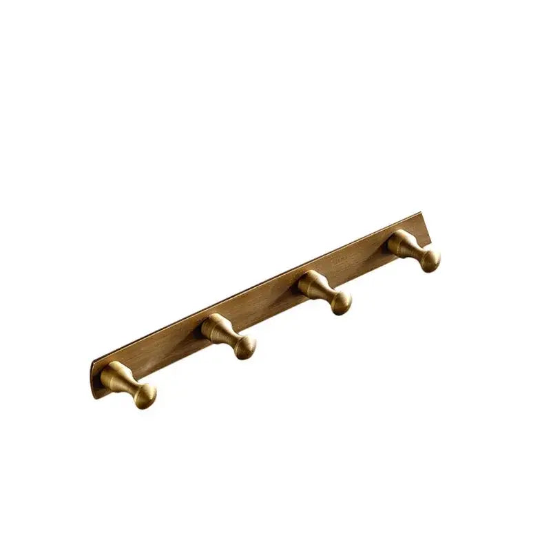 Brass-colored DecorBites™ robe hook with three rounded hooks in antique brass finish for bathroom accessories