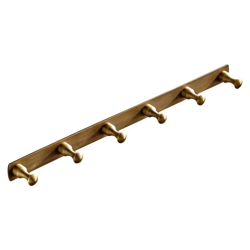Gold-toned metal wall-mounted coat rack with five rounded pegs in antique brass finish robe hook for bathroom accessories