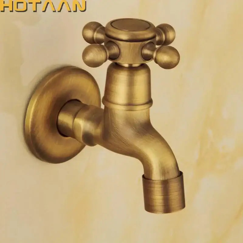Antique brass finish wall mount garden bibcock faucet with cross handle and decorative spherical knobs by DecorBites™