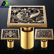 Brass-finished square shower drain with antique brass fish design featuring lotus flowers for floor use