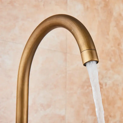 DecorBites antique brass floor mount tub faucet with swivel spout and mixer tap featuring a sleek curved design