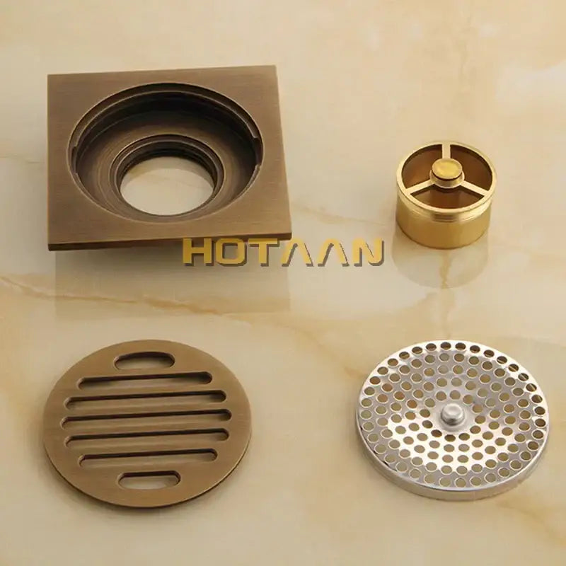 Decorbites antique brass flower art floor drain assembly with square and round components for bathroom use
