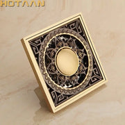 Decorbites antique brass flower art floor drain with brass finish and intricate black and gold filigree design