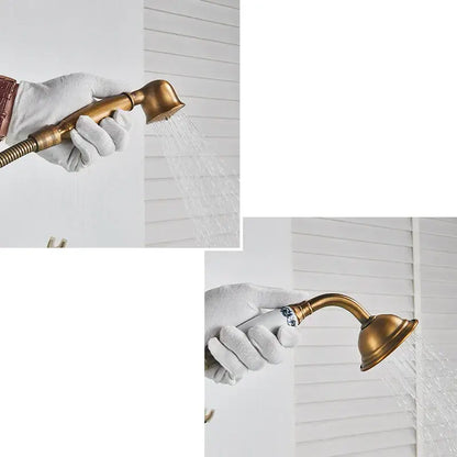 Antique brass freestanding bathtub filler with handheld showerhead featuring curved spout and blue floral handle detailing