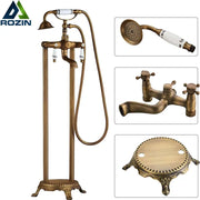 DecorBites antique brass freestanding bathtub filler with white ceramic handles and matching hand shower in brass freestanding bathtub style