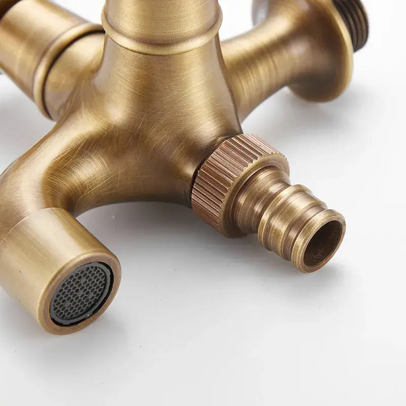 Antique brass garden bibcocks three-way outdoor faucet with textured finish and threaded hose connections by DecorBites