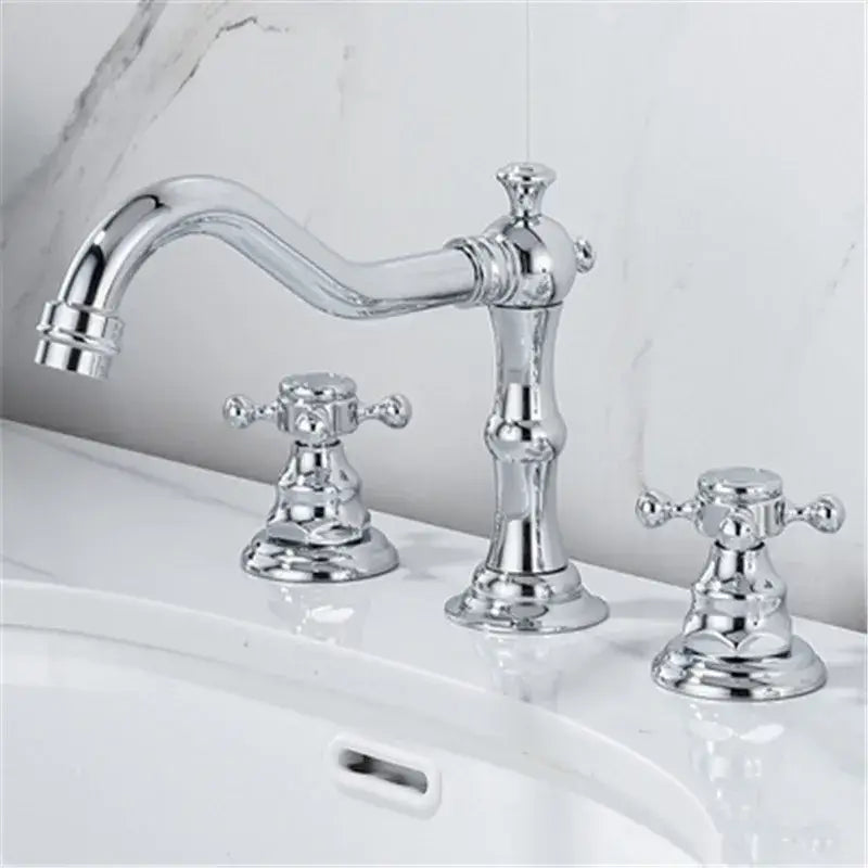 Chrome finished ornate vintage style basin faucet with curved spout and double cross handles for brass gold bathroom use