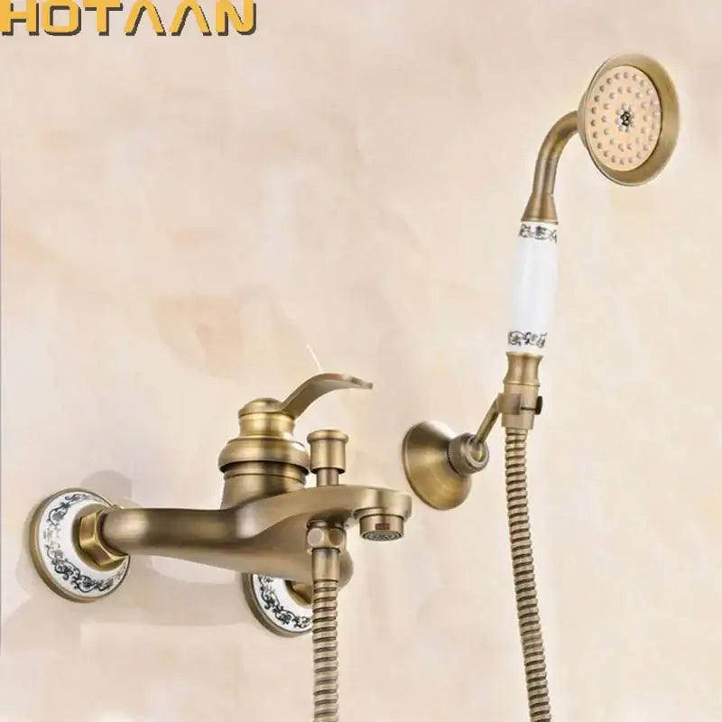 Antique brass shower head kit with white ceramic handle and blue floral patterns for wall mounted bathtub use