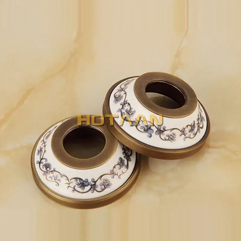 Decorbites antique brass shower head kit features ceramic toilet paper holders with blue floral patterns on white background