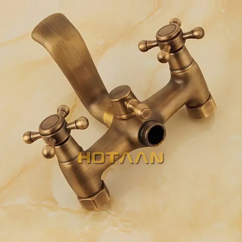 Decorbites antique brass hand-held shower head kit featuring a wall mounted antique brass faucet with cross handles