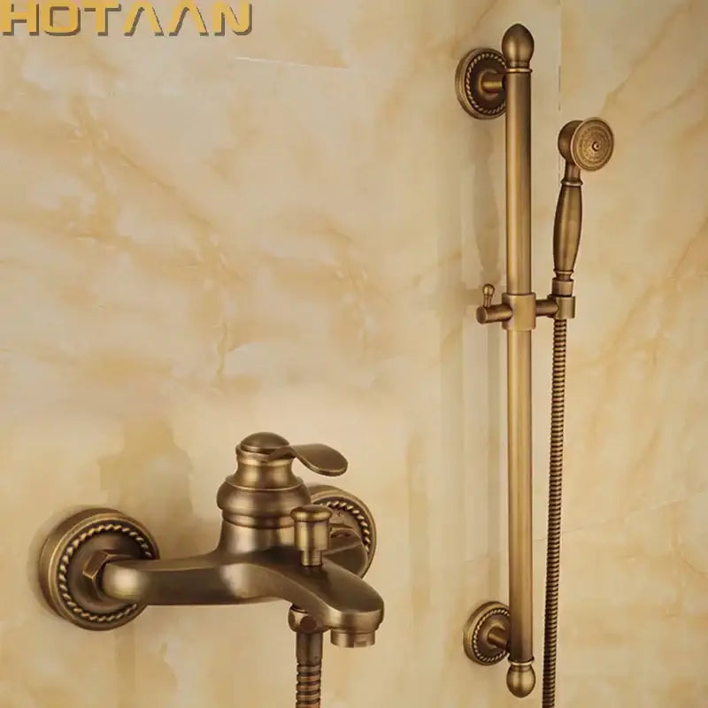 Decorbites antique brass shower head kit with ornate detailing featuring a bathroom faucet and handheld shower set