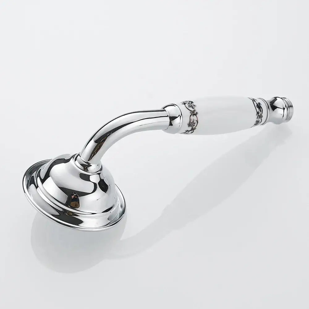 Chrome finished hand held shower with white ceramic handle and intricate silver floral detailing in brass hand held design