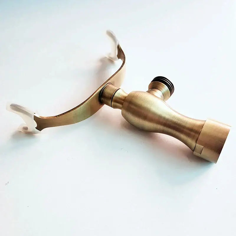 Brass-finished hand shower holder bracket with curved spout and dual handles for wall mount bathroom accessories