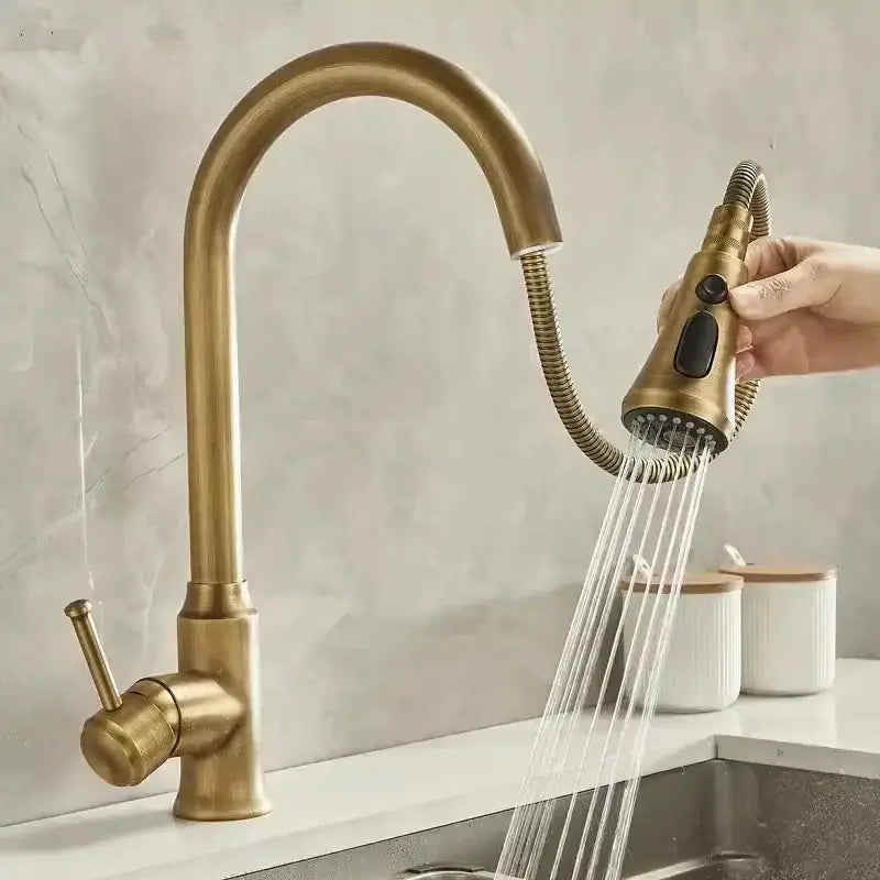 Brass kitchen faucet with curved spout and pull-out spray head in antique brass for 360° rotation sink use