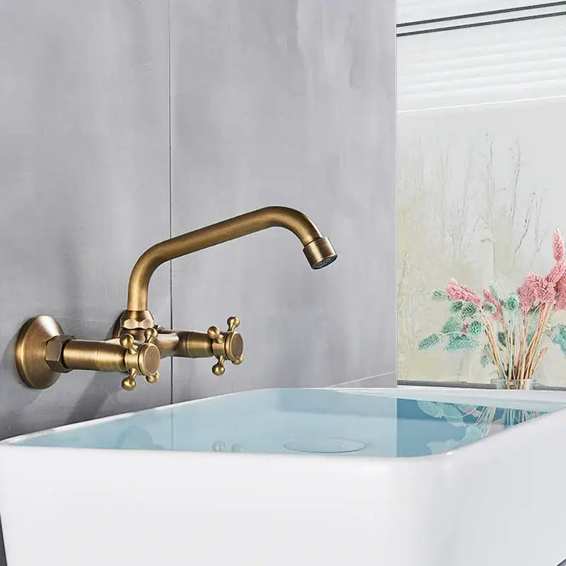 Decorbites antique brass kitchen faucet with swivel spout and dual ornate cross-handle brass mixer