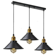 Black industrial-style DecorBites antique brass kitchen pendant light with brass accents and exposed filament bulbs