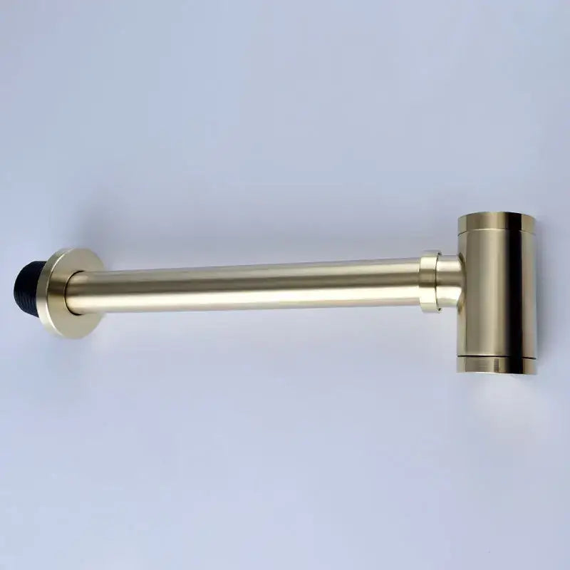 Gold-finished metal door stop with black rubber tip complementing antique brass bathroom sink drain kit accessories