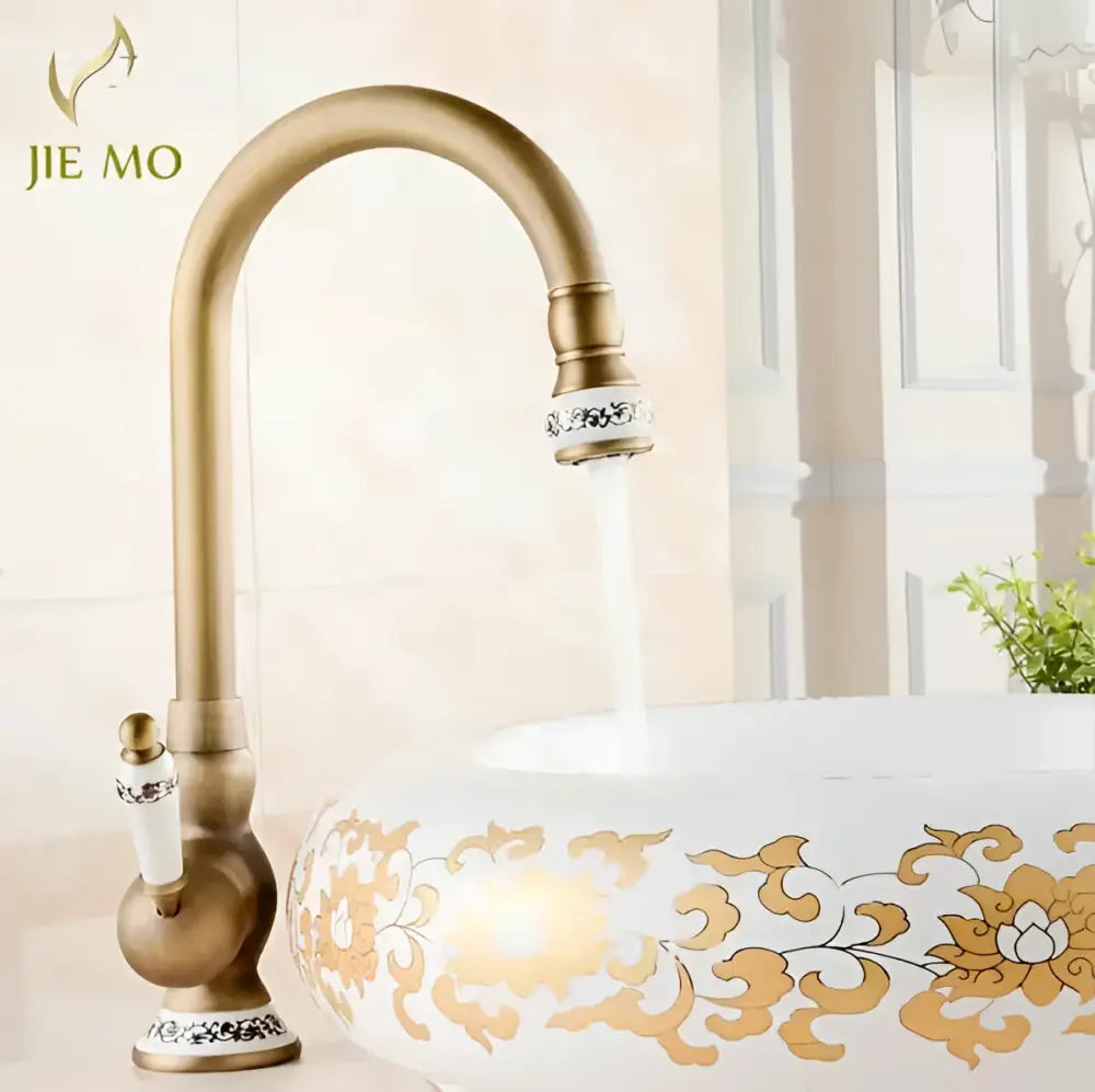 Decorbites antique brass porcelain basin mixer with ornate white ceramic handle and decorative silver inlay accents