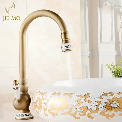 Decorbites antique brass porcelain basin mixer with ornate white ceramic handle and decorative silver inlay accents