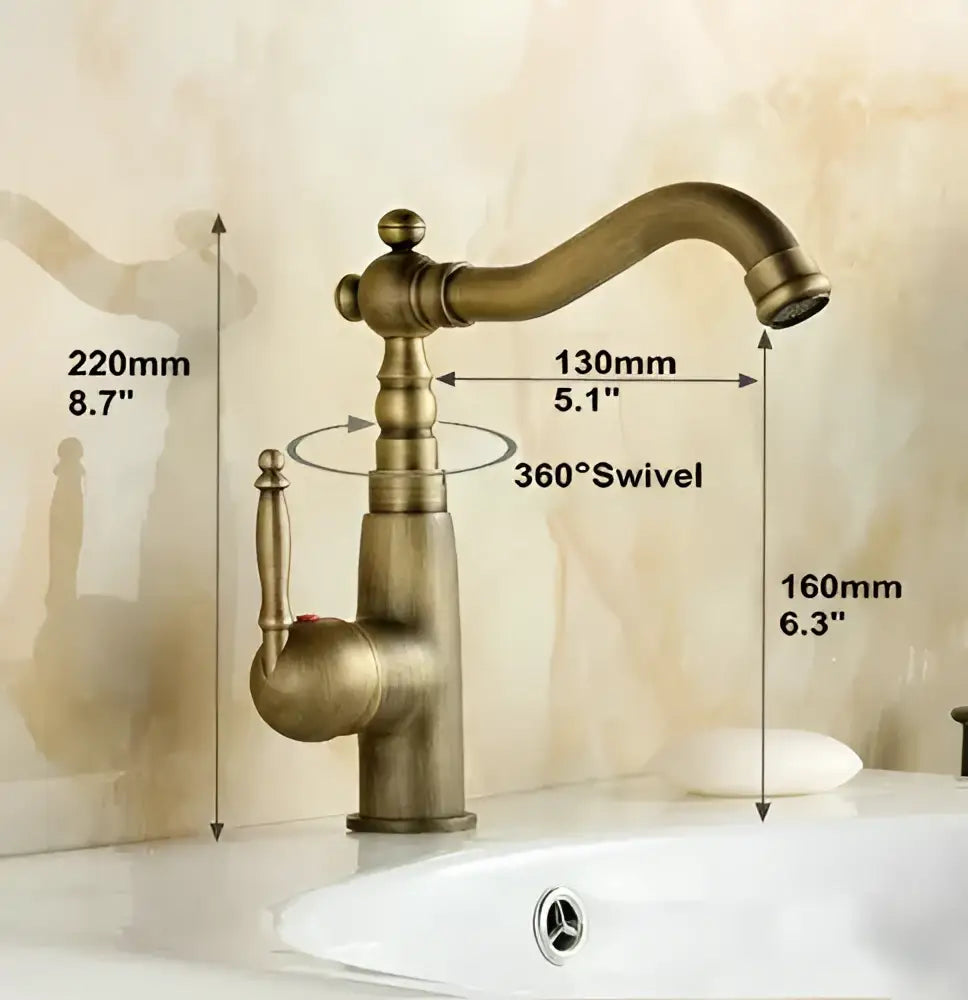 Antique brass porcelain basin mixer with single-handle curved spout and ornate detailing for bathroom use