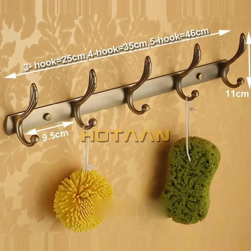 Bronze-finished metal robe hook rack with five curved hooks in antique brass for bathroom accessories and hardware
