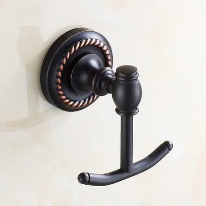 Antique brass robe hook with bronze finish and ornate rope detailing on circular wall plate for bathroom towels