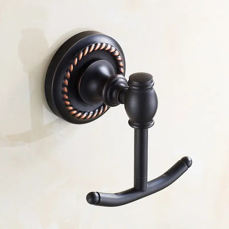 Antique brass robe hook with bronze finish and ornate rope detailing on circular wall plate for bathroom towels