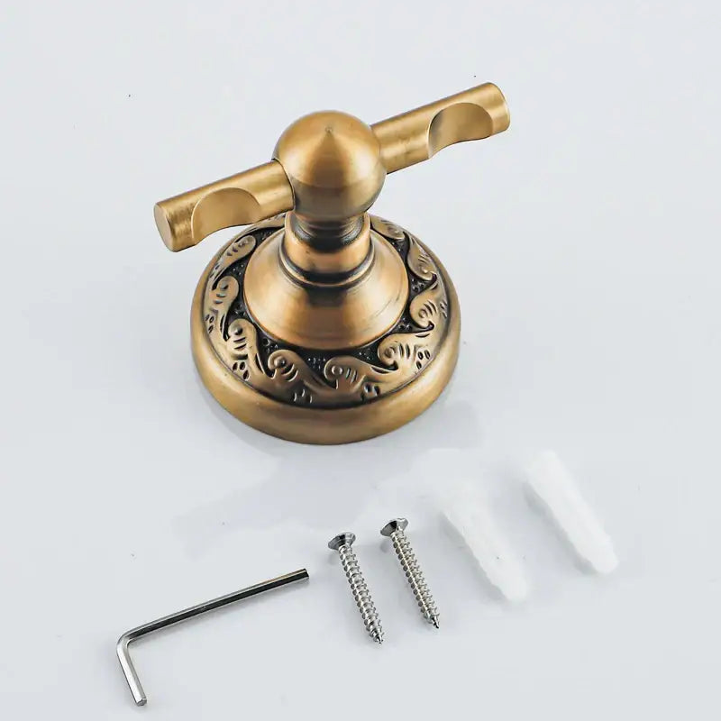DecorBites antique brass robe hook with ornate swirling patterns on a durable aluminium double towel hook base