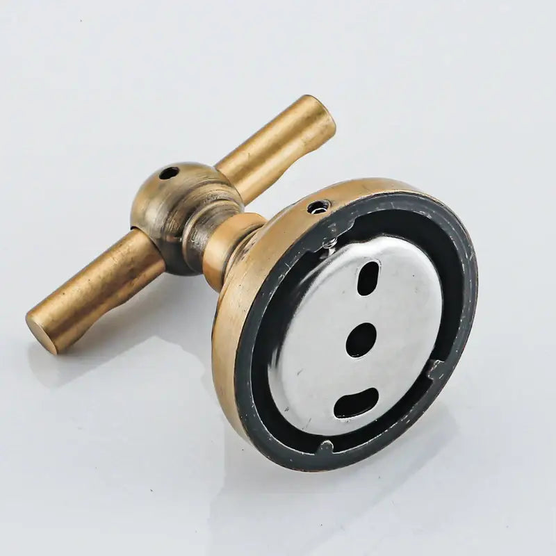 Brass-finished bathroom faucet with circular base and two handles alongside decorbites antique brass robe hook in aluminum