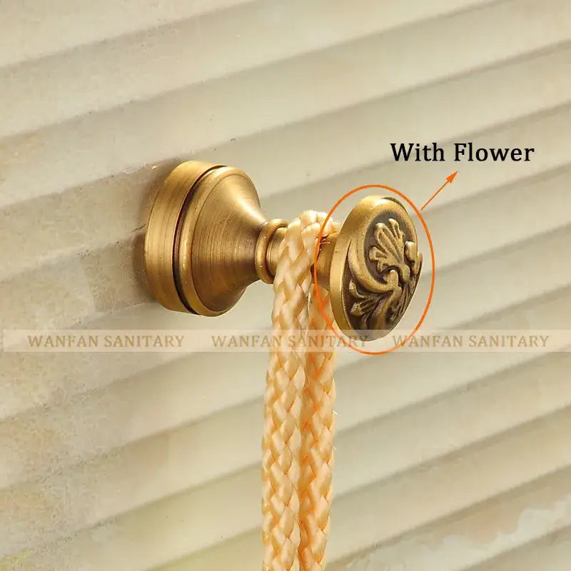 Decorbites™ antique brass robe hook with ornate floral design and braided beige rope for clothes and towels