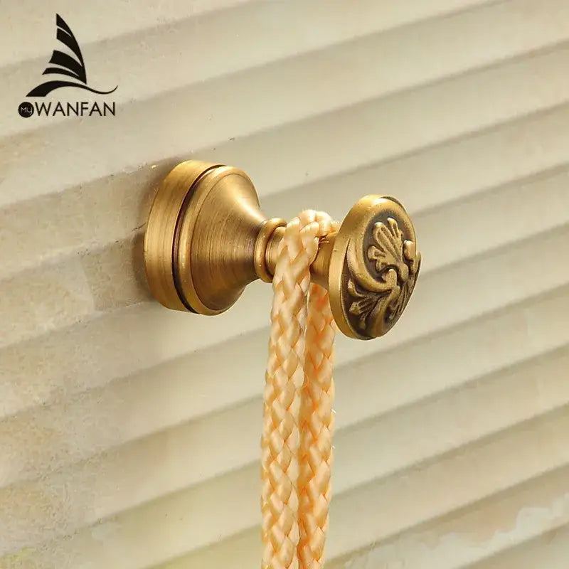 DecorBites™ antique brass robe hook with ornate floral engraving and braided cream rope for towel or coat hanging
