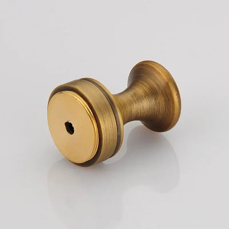 Decorbites antique brass robe hook with brushed metal texture and central mounting hole for clothes and towels