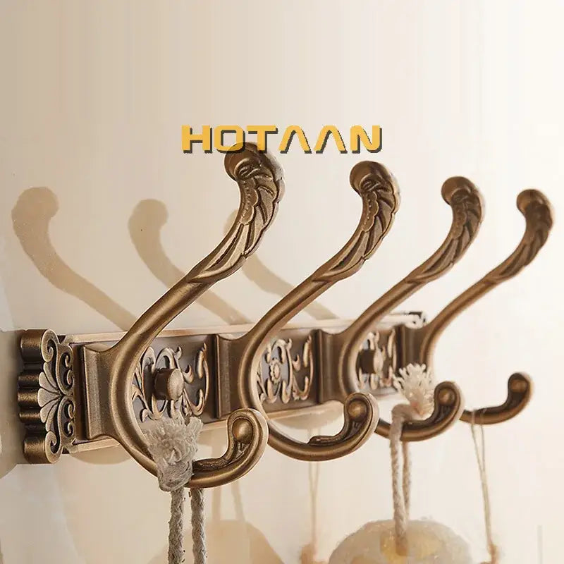 Antique brass robe hook wall mount with ornate scrollwork and floral patterns by decorbites for bathroom use