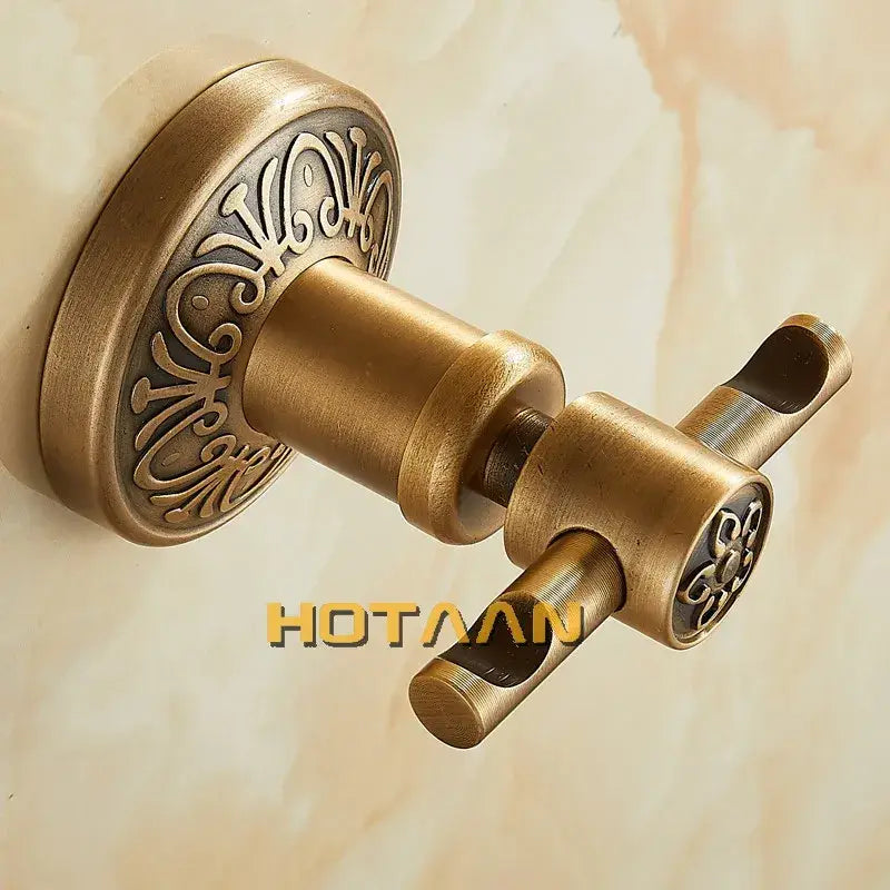 Decorbites™ antique brass robe hook wall mounted with ornate scrollwork on circular base and handle ends brass robe hook