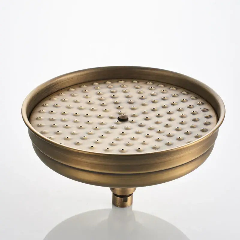 Antique brass shower faucet set featuring a circular rain head with evenly spaced nozzles and central adjustment knob