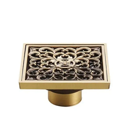 Rectangular antique brass shower floor drain with ornate scrollwork design for decorative bathroom waste strainer cover