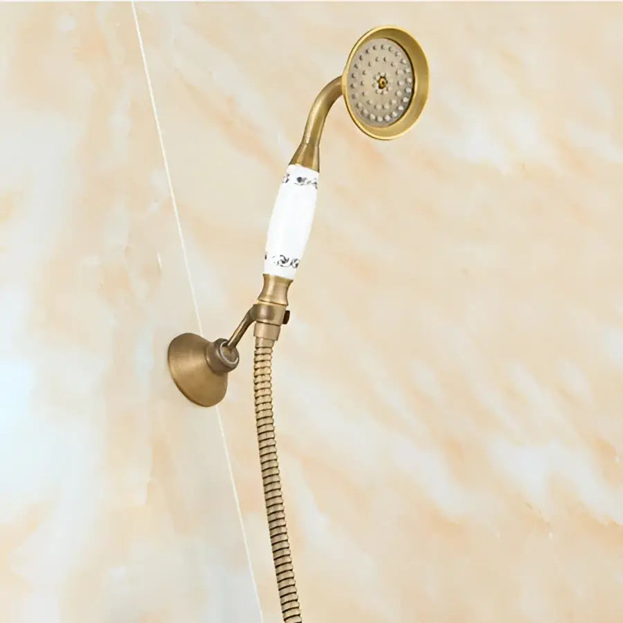 Antique brass shower set with 8 inch rain head and ceramic handle featuring floral patterns and flexible metal hose
