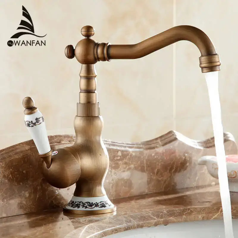 DecorBites antique brass single handle basin faucet with white ceramic handle and black ornate detailing on base