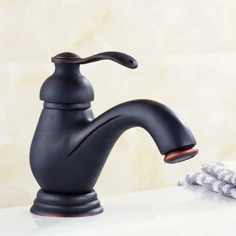 Decorbites™ antique brass single handle deck mount bathroom sink faucet with bronze finish curved spout and decorative base