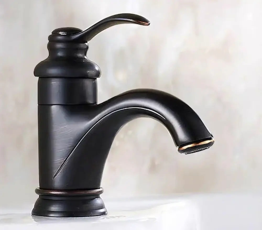 Decorbites™ antique brass single handle deck mount bathroom sink faucet with black matte curved spout and arched handle