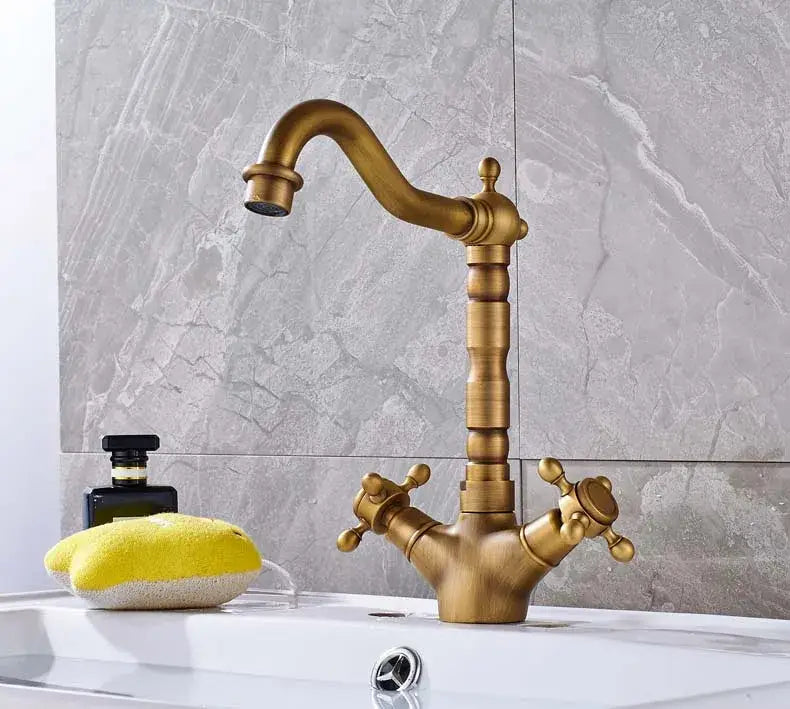 Decorbites antique brass kitchen sink faucet with vintage brass finish, ornate spout, and dual cross-handle controls