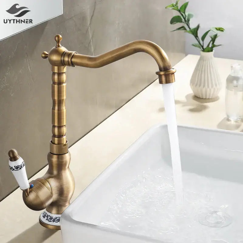 DecorBites antique brass kitchen sink faucet with ornate vintage design and white ceramic handles with blue patterns