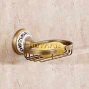 Antique brass soap holder by decorbites featuring a white ceramic backplate with black floral patterns and a yellow soap bar