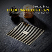 Selected brass square bath drain strainer in antique brass featuring parallel slats and a central rectangular opening