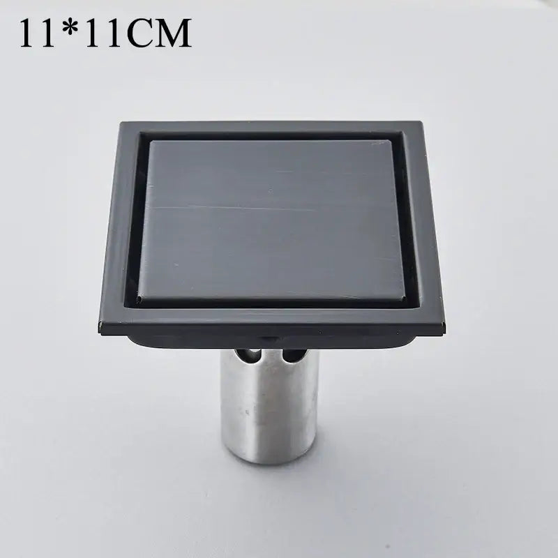DecorBites™ antique brass square fish carved floor drain with matte black finish and silver metallic stand 11x11 cm