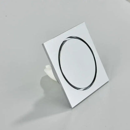 Chrome-finished square bathroom floor drain with sleek oval opening in DecorBites™ antique brass square fish carved design